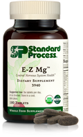 Image of E-Z Mg bottle next to tablets of magnesium supplements.